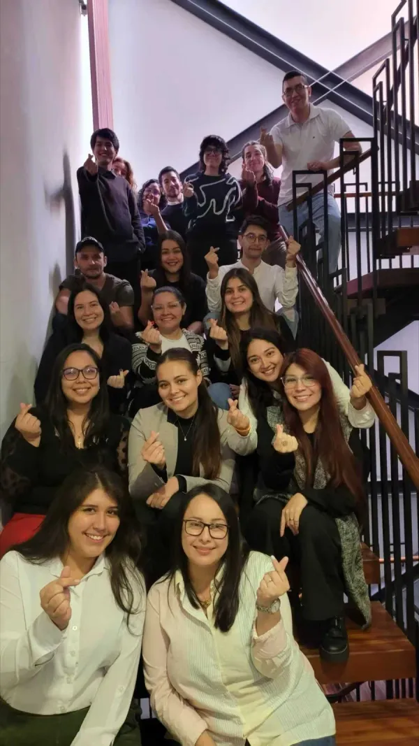 Callnovo team group photo on staircase with heart gestures