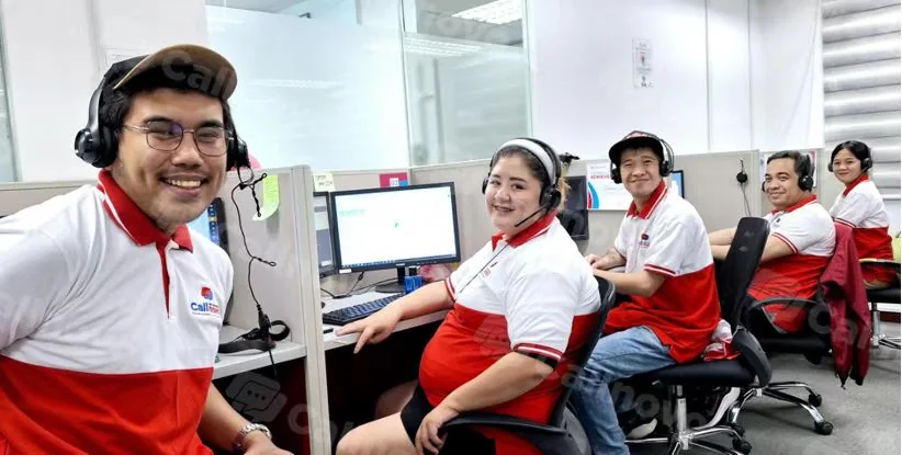 Callnovo customer service agents in branded polos and headsets at their workstations