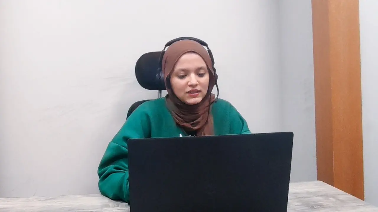 Eine Mitarbeiterin mit Headset arbeitet an einem Laptop an einem Einzelarbeitsplatz – Call Center Software