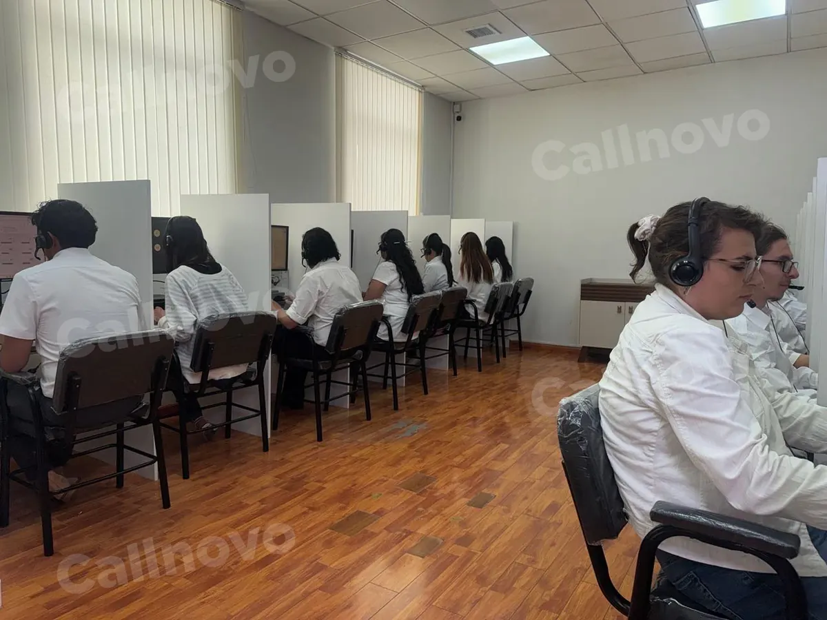 Callnovo.ai human agents wearing headsets take calls at a row of desks in one of our operations centers