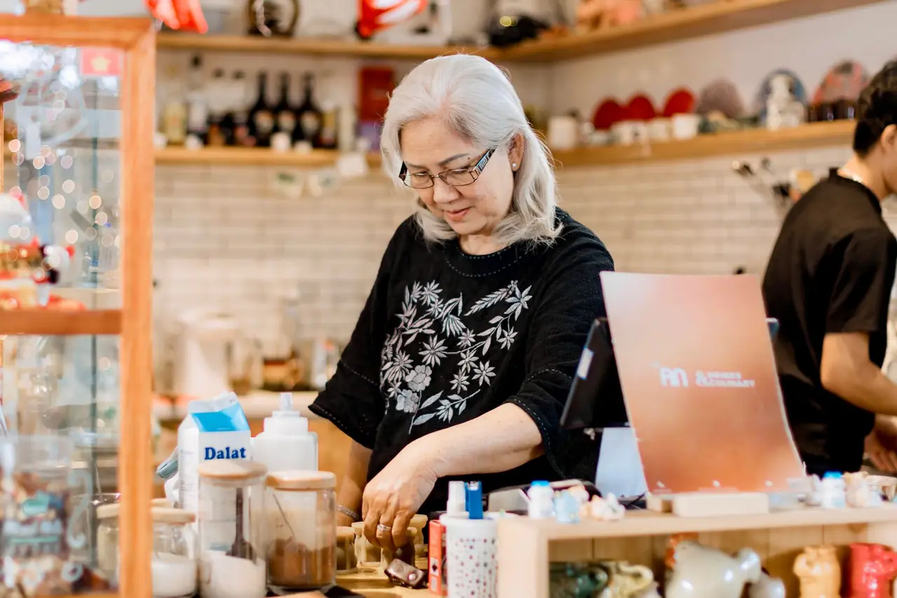 A small business owner on the phone in their workspace